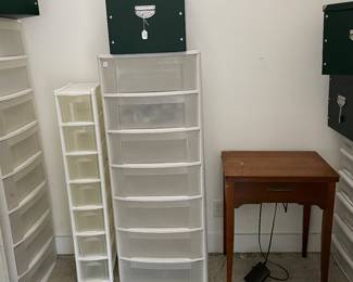 Lots of plastic storage and sewing machine 