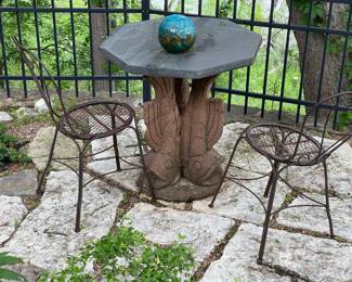 Hand carved fish table base with slate top, two metal garden chairs
