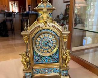 French Champlev'e enamel and gilt bronze table clock Circa 1870/1880 in the classic Louis-Philippe style. Case: Gilt Bronze with gilt bronze cherubs, columns, and finials enriched with Champlev'e enamel including the dial.