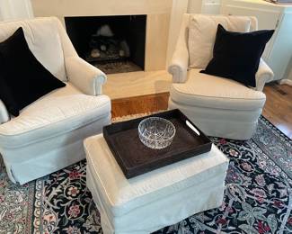 Light gray velvet swivel armchairs with ottoman