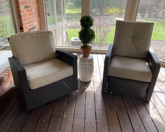 All-season wicker patio furniture. One is a swivel rocker, one is a recliner.