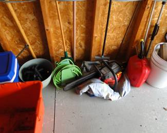 More cords, gas cans, and other lawn items, such as a chainsaw