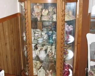 curved glass china cabinet and it is loaded with some nice pieces