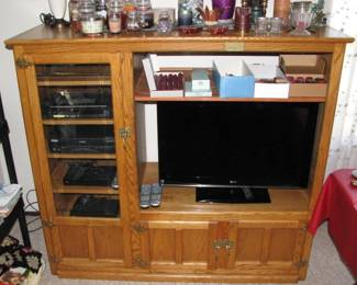 this is not your average junk entertainment center, this is solid oak, will fit a decent size flat screen and has some nice hardware.