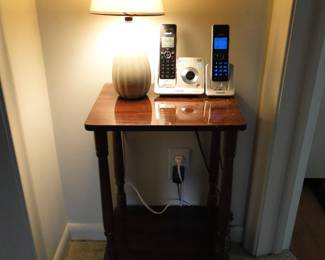 Vintage lamp, a pair of phones, and a nice two tier table