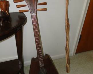 Some serious imagination went into making this guitar.  Nice comfortable wood walking stick