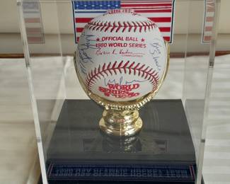 1980 World Series Rawling Baseball In Custom Display Case Autographed By All 20 Players Of The 1980 USA Olympic Hockey Team From The "Miracle On Ice" Game. (Certified By Grandstand Sports & Memorabilia). Team Photo Measures 8.5x11.