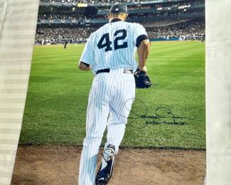 Photograph Of NY Yankees Mariano Rivera #42 2006 Entering The Game Autographed By Mariano Rivera With "Enter Sandman" Inscription. (Certified By Steiner Sports With Identification Card). Measures 13x20.
