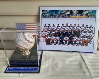 1980 World Series Rawling Baseball In Custom Display Case Autographed By All 20 Players Of The 1980 USA Olympic Hockey Team From The "Miracle On Ice" Game. (Certified By Grandstand Sports & Memorabilia). Team Photo Measures 8.5x11.
