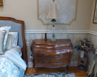 Mahogany frame upholstered headboard/footboard & bed frame, pair of bombe chest night tables, pair of lamps