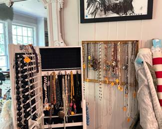A multitude of vintage costume jewelry and Penley art