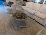 Large oval glass coffee table on Urn