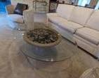 Large oval glass coffee table on Urn