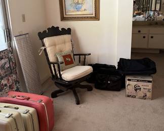 This sturdy wooden office chair would be good to use while contemplating your next travel with the suitcases.