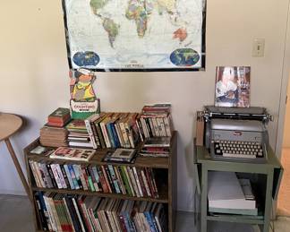 Next to the typewriter here is the bookshelf full of books.  Don't forget the map of the world on the wall.