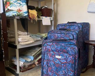 Ricardo luggage set and shelves of linens, scarves, etc.