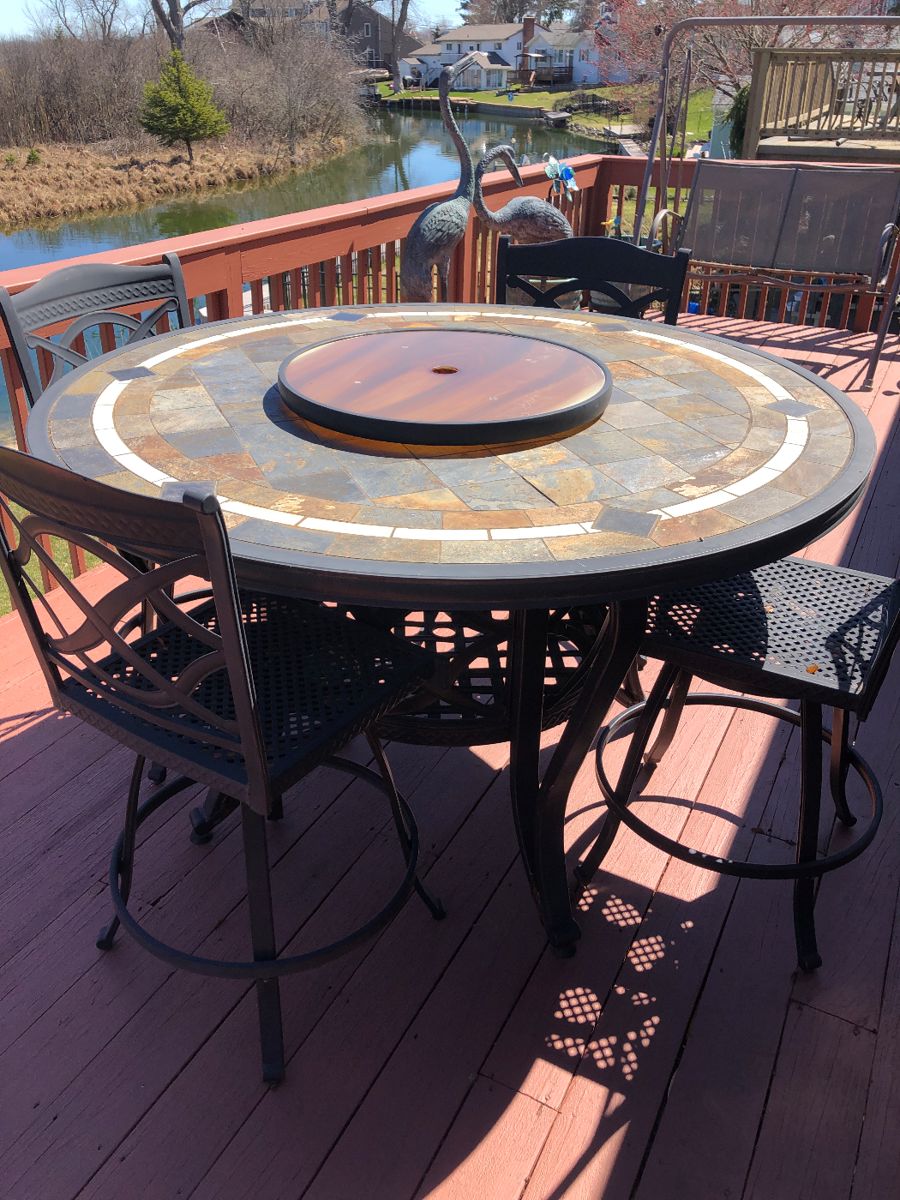 Starting with outdoors for the Season! Nice round tile top - counter height table with six swivel chairs - lazy/susan center 