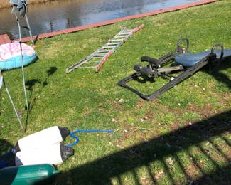 Aluminum folding ladder, Invertor back table on grass, boat fenders & lawn art  