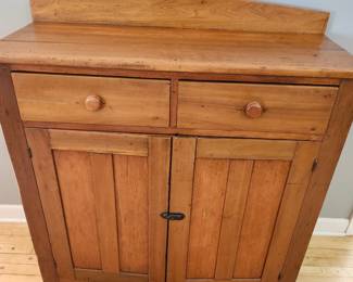Antique light colored cabinet with 2 drawers.