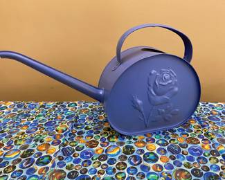 Periwinkle metal watering can with embossed rose