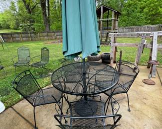 Wrought iron table and 4 chairs with umbrella and base. 