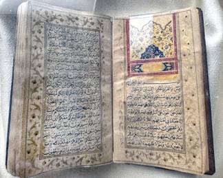 Koran illuminated manuscript book in shadow box frame, written in Arabic, early 19th century
