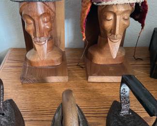 Ecuadorian wooden head statues/bookends; assorted antique irons; embroidered hats
