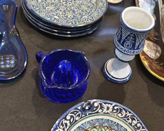 Assorted hand-painted Uzbekistan dishware, including dessert plates, bowls and mugs