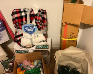 Variety of items, box of Hawaiian leis, and a bag of Christmas lights