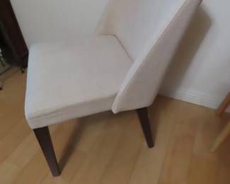 Four upholstered dining chairs.