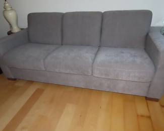 Grey fabric sleeper sofa.