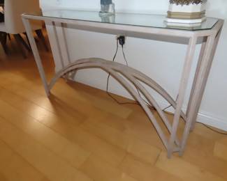 Glass and powder coated metal sofa table.