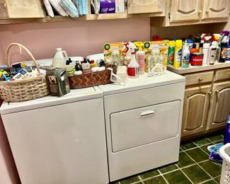LAUNDRY ROOM WITH LOTS OF CLEANING SUPPLIES, WHIRLPOOL WASHER AND DRYER.