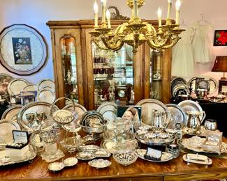 DINING ROOM FULL OF SILVERPLATE SERVING TRAYS AND PLATTERS.  CURIO IS NOT FOR SALE.
