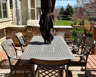 Take a look at this very unique Patio Table and Chairs.  Made from Aluminum Cast with Lattice Woven Style in the Chairs and Table.  The design features a Copper Element to the Chairs, Table and Umbrella Stand. The Table is 72" Long and 41" Wide.  There are 2 Swivel Rockers and 4 Dining Chairs. The cushions are in great condition by Sunbrella and  the Umbrella is from Garden Treasures and in Rectangular in shape . Purchased from Great Escape.