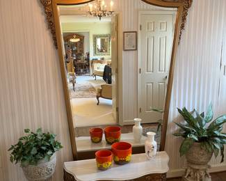 Get ready to step back in time! The foyer greets you with this massive Hollywood Regency pier mirror and base.  