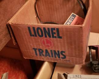 Lionel train set with locomotives, cars, tracks, and transformer