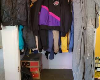 A bunch of vintage mens motorsports boots, helmets, jackets, and accessories 