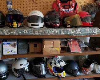 Several motorcycle, motocross, and snowmobile helmets