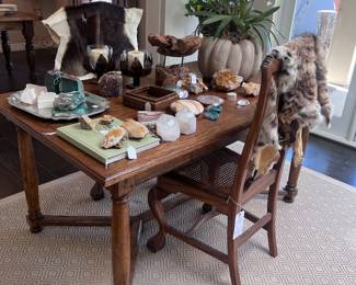 Antique dining refractory table, pair of Chippendale cane seat chairs, bobcat and antelope pelts, beautiful tabletop accessories 
