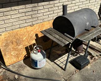 Barbecue grill, propane tank, plywood