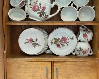 Miniature china tea set in cabinet