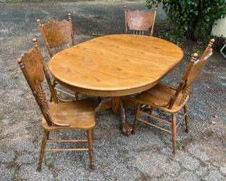 Heavy Oak Dining table, Round or Oval (with leaf installed) and 4 chairs.  Great Condition.