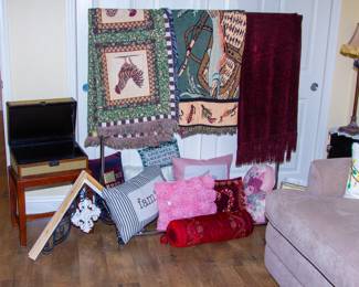 Assortment of decorative pillows and blankets