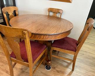 Round claw foot dining table with six chairs