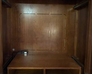 Inside of top of entertainment center, shelf can be removed if wanted for shirts,