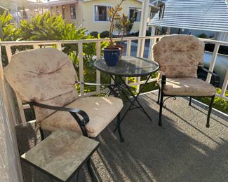 Black wrought iron garden arm chairs, with cushions, tables,