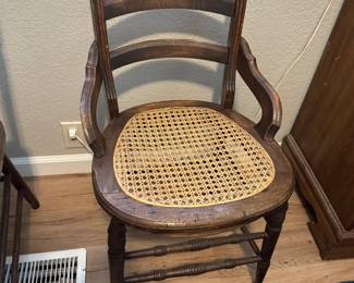 Wood side chair with arms, caned seat