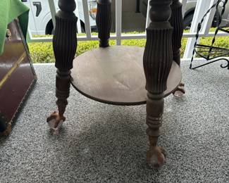Base of round table with metal claw on glass ball feet, metal is rusted 