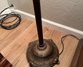 Base of standing floor lamp showing metal work